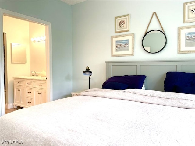 bedroom with ensuite bath and sink