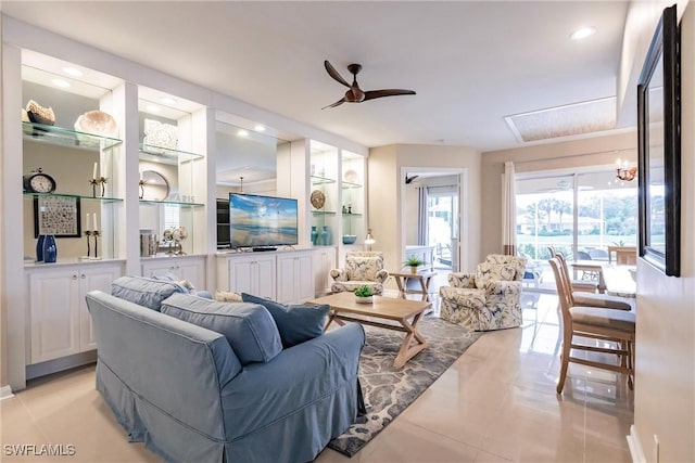 living room with ceiling fan, light tile patterned flooring, and built in shelves