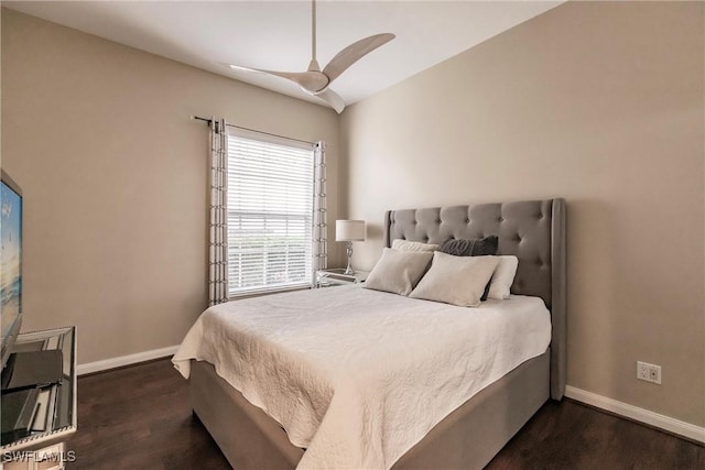 bedroom with dark hardwood / wood-style flooring and ceiling fan