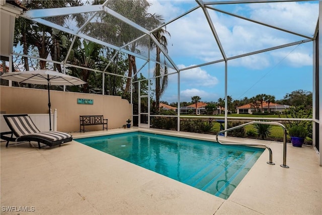 view of swimming pool featuring a patio area and a lanai