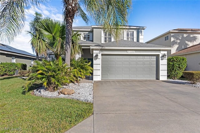 view of front of home featuring a garage and a front lawn