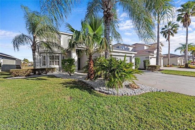 view of front facade with a garage and a front lawn