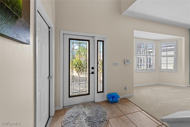 carpeted entrance foyer featuring plenty of natural light