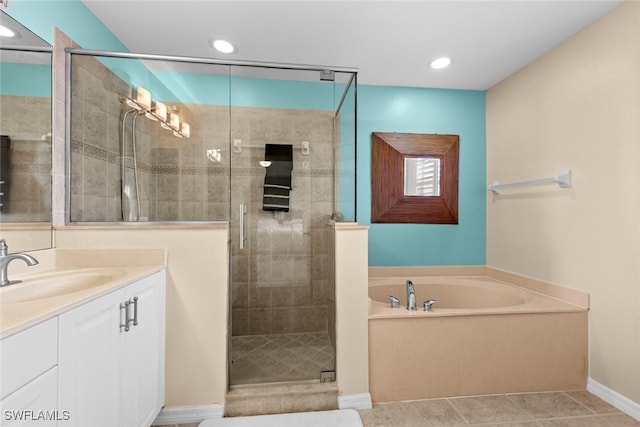 bathroom with tile patterned flooring, vanity, and separate shower and tub