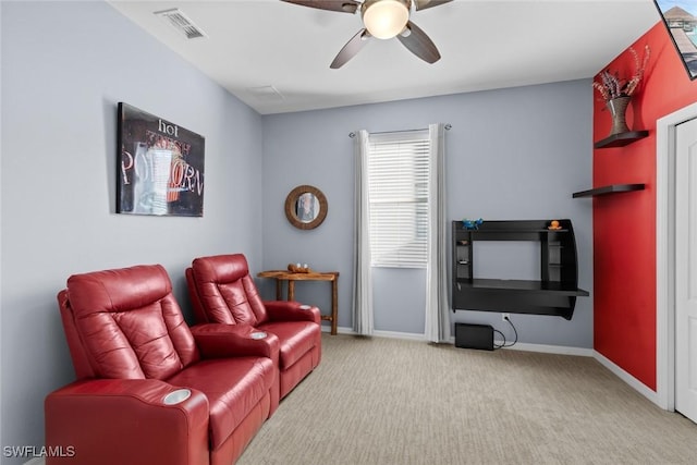 interior space featuring light carpet and ceiling fan