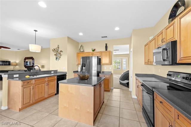 kitchen featuring black appliances, sink, hanging light fixtures, light tile patterned floors, and a kitchen island