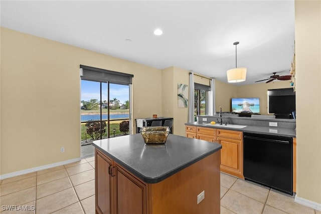 kitchen featuring ceiling fan, sink, hanging light fixtures, black dishwasher, and light tile patterned floors