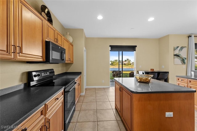 kitchen with black appliances, a center island, and light tile patterned floors