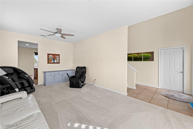 living area with ceiling fan and light tile patterned floors