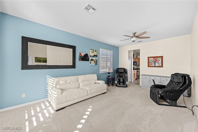 living room with ceiling fan and light carpet