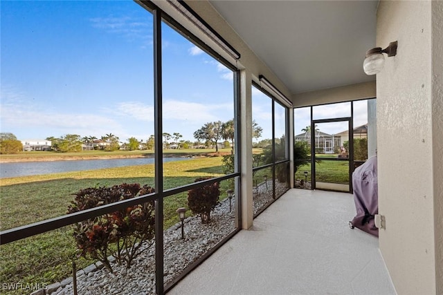 sunroom / solarium featuring a water view