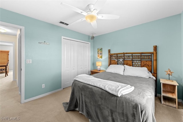 carpeted bedroom featuring ceiling fan and a closet