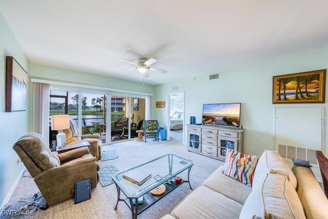 living room with carpet flooring and ceiling fan