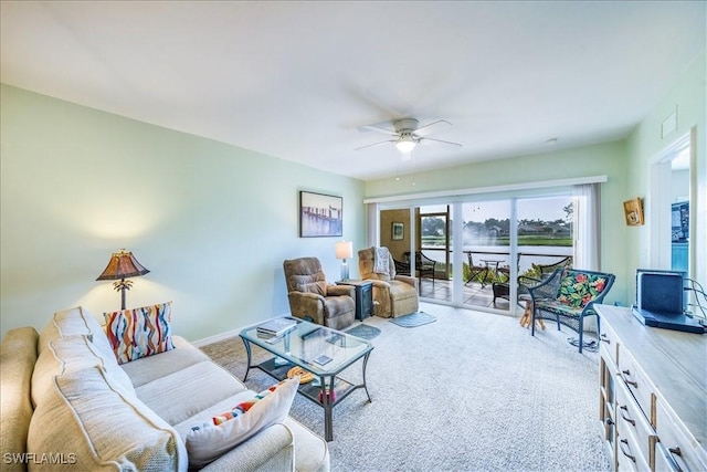 carpeted living room with ceiling fan