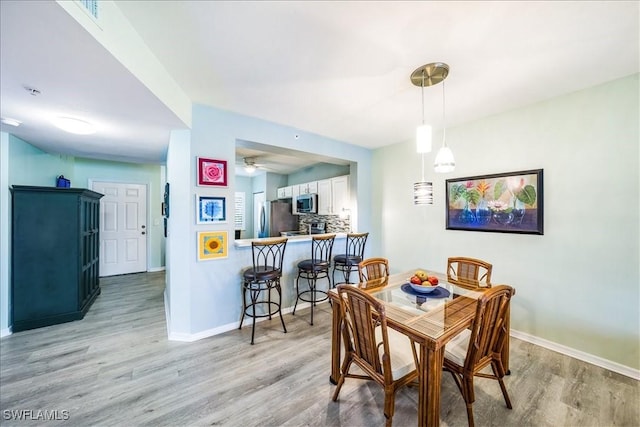 dining space featuring light hardwood / wood-style flooring