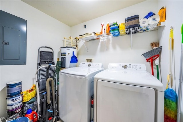 washroom featuring washer and dryer, electric panel, and water heater