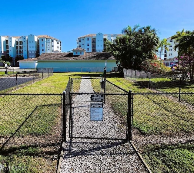 view of gate featuring a lawn