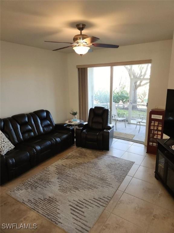 living room with ceiling fan and light tile patterned floors