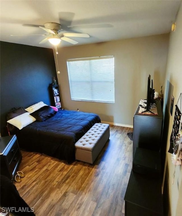 bedroom with ceiling fan and dark hardwood / wood-style flooring