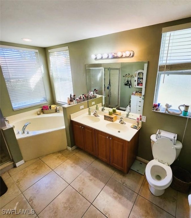 bathroom with plus walk in shower, vanity, and tile patterned floors