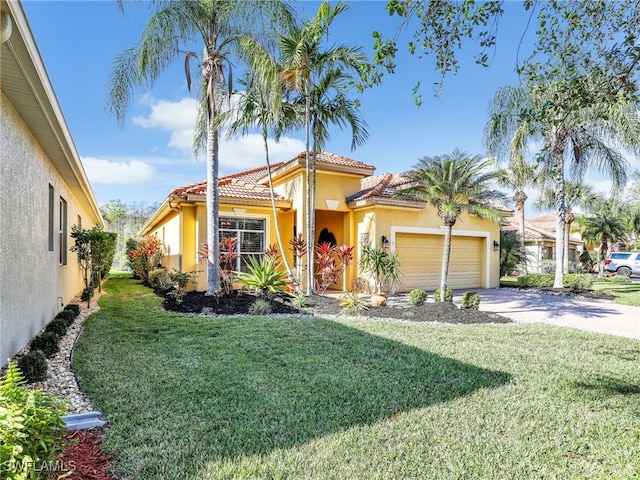 mediterranean / spanish house with a front yard and a garage