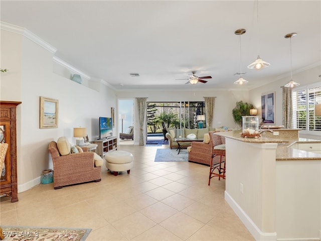 living room with ceiling fan, ornamental molding, and light tile patterned floors