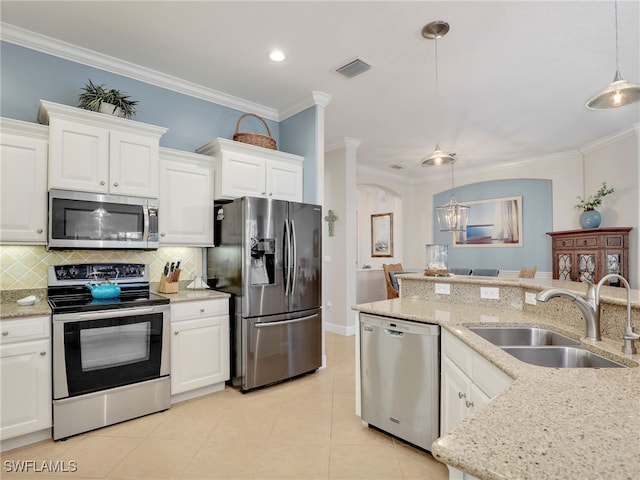 kitchen with sink, stainless steel appliances, white cabinets, and pendant lighting