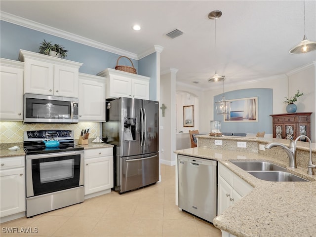 13538 Troia Dr, Estero, FL 33928 - kitchen featuring decorative backsplash, a sink, ornamental molding, and appliances with stainless steel finishes
