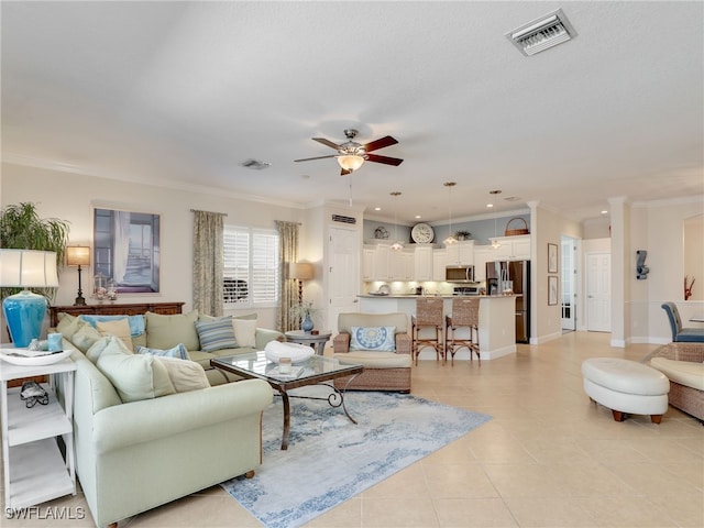 tiled living room featuring a textured ceiling, ceiling fan, and crown molding