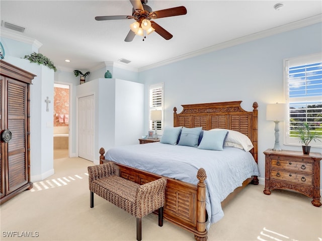 carpeted bedroom with ceiling fan, connected bathroom, and crown molding