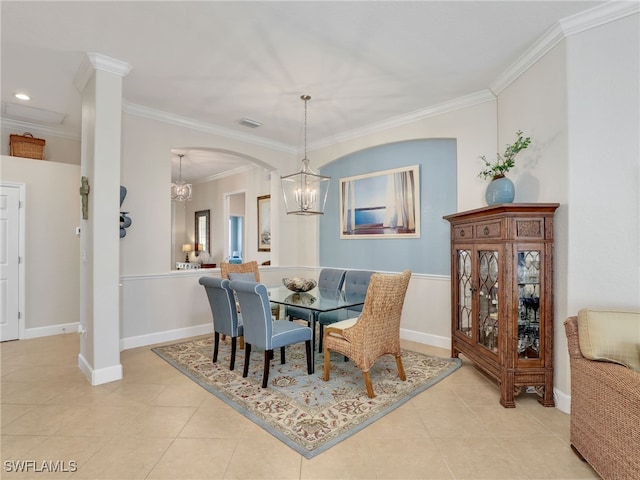 dining room with an inviting chandelier, light tile patterned floors, and crown molding