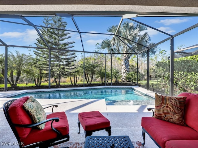 view of pool featuring a patio and glass enclosure