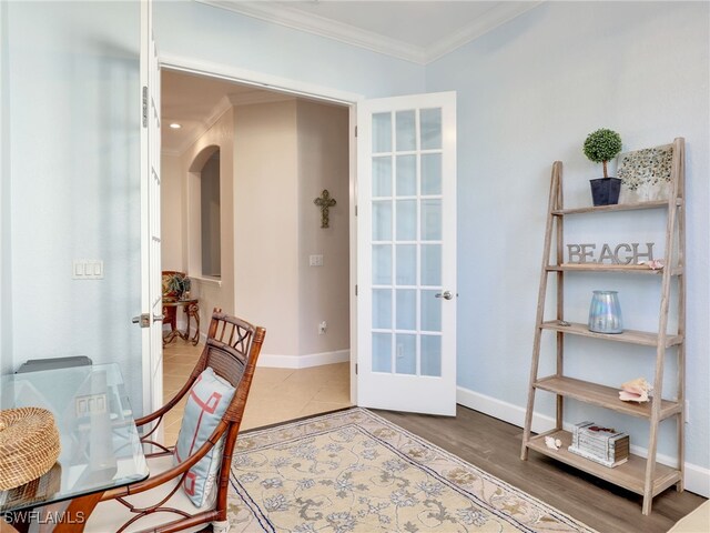 dining area with french doors and crown molding