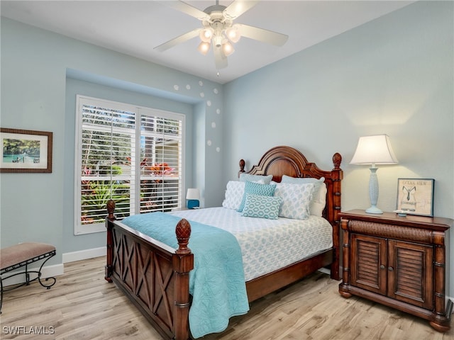 bedroom with ceiling fan and light hardwood / wood-style floors