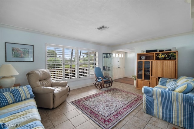 living room featuring crown molding and light tile patterned floors