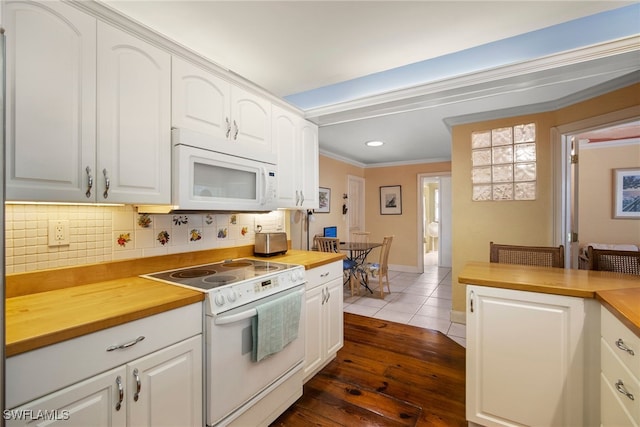 kitchen featuring white appliances, backsplash, wooden counters, ornamental molding, and white cabinetry