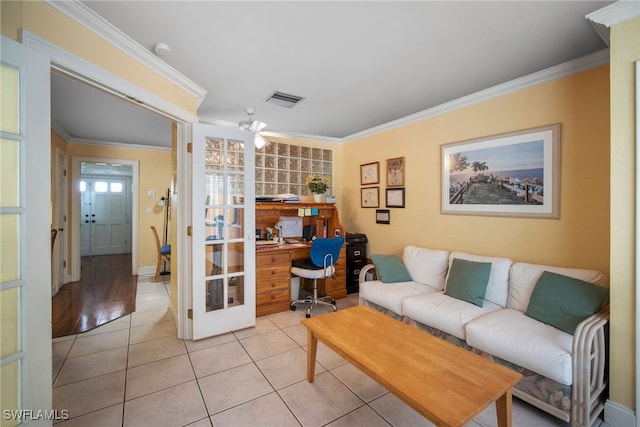 living room featuring ceiling fan, light tile patterned floors, and crown molding