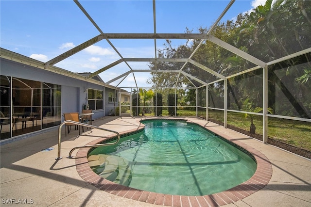 view of pool with a patio and a lanai