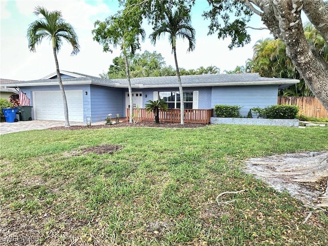 ranch-style house featuring a garage and a front yard