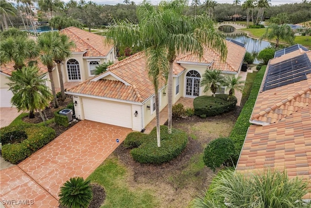 mediterranean / spanish-style home with a water view