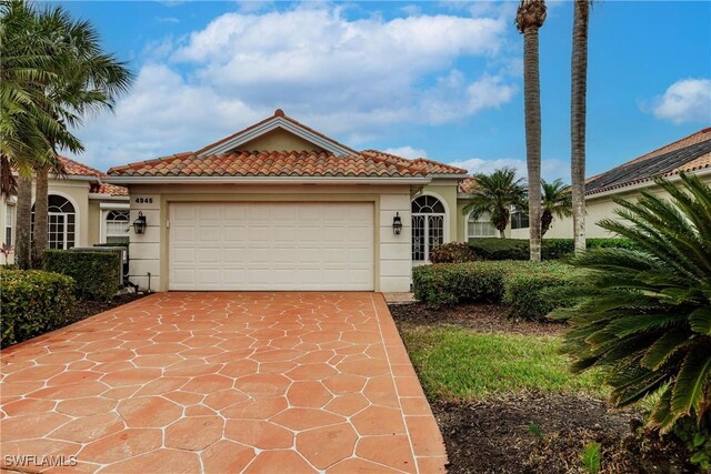 mediterranean / spanish house with a garage