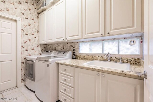 laundry room featuring cabinets, independent washer and dryer, light tile patterned floors, and sink