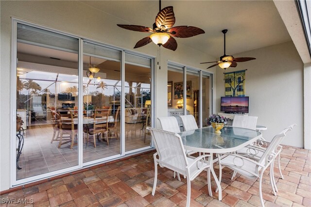 sunroom featuring a patio area