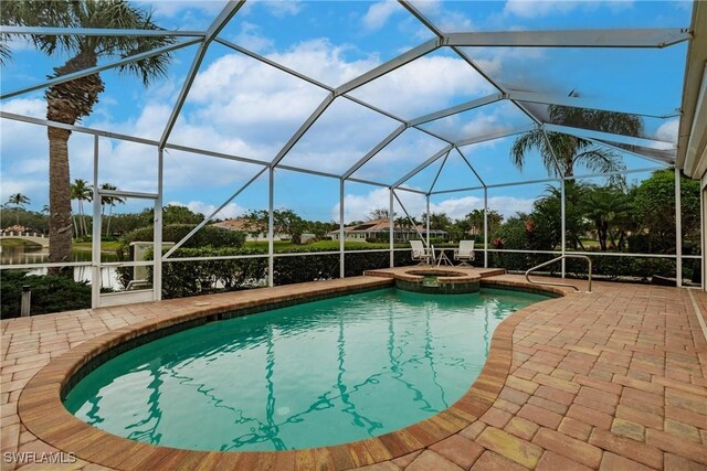 view of swimming pool featuring a patio area, an in ground hot tub, and glass enclosure