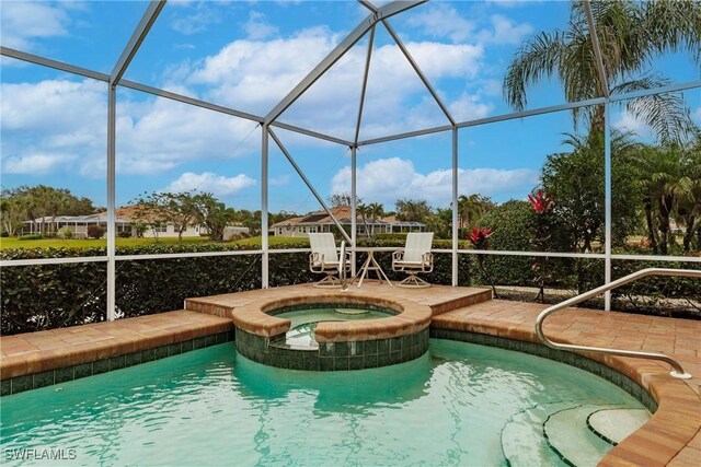 view of pool featuring an in ground hot tub, a patio, and a lanai