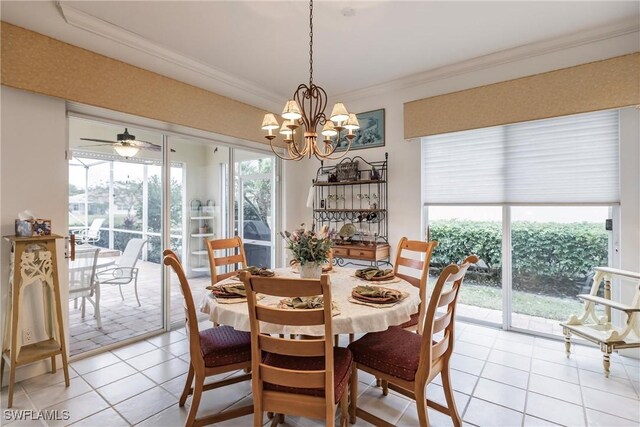 tiled dining area with crown molding and an inviting chandelier