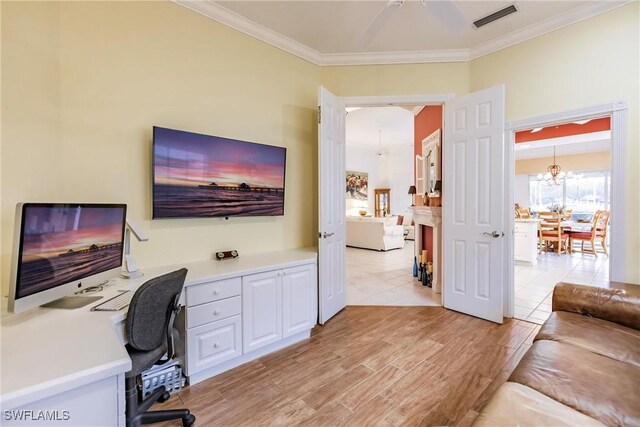 home office featuring light hardwood / wood-style flooring, crown molding, and a notable chandelier