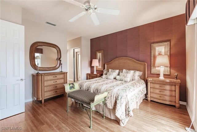 bedroom featuring ceiling fan, a closet, and hardwood / wood-style floors