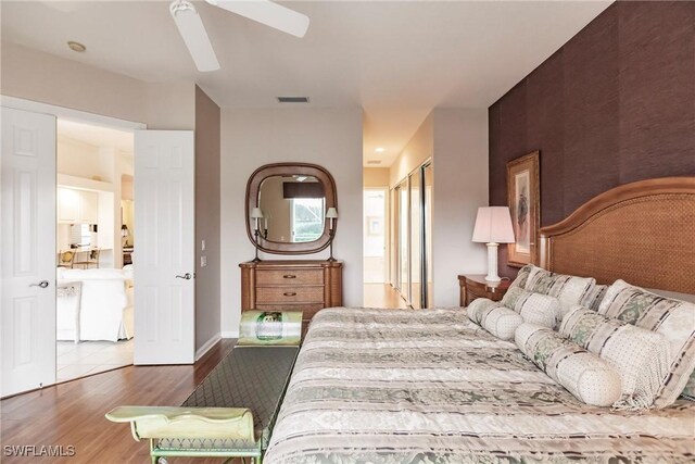 bedroom with hardwood / wood-style floors and ceiling fan