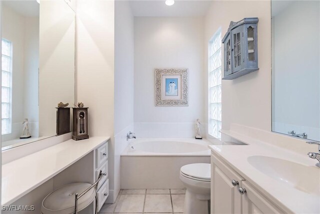 bathroom featuring a tub to relax in, toilet, tile patterned flooring, and plenty of natural light